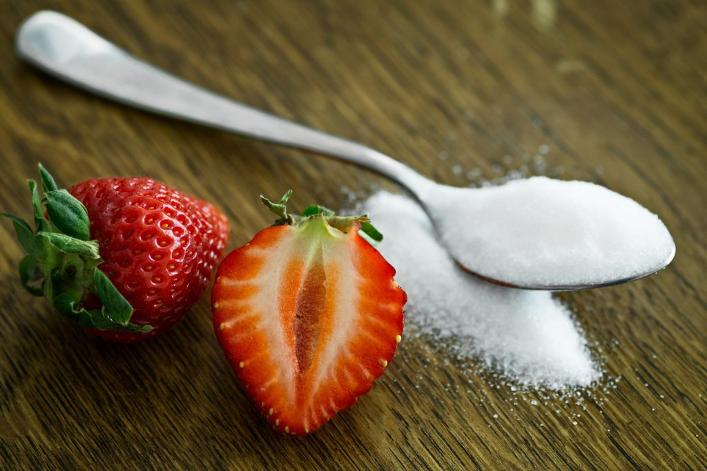 spoon of sugar and strawberries