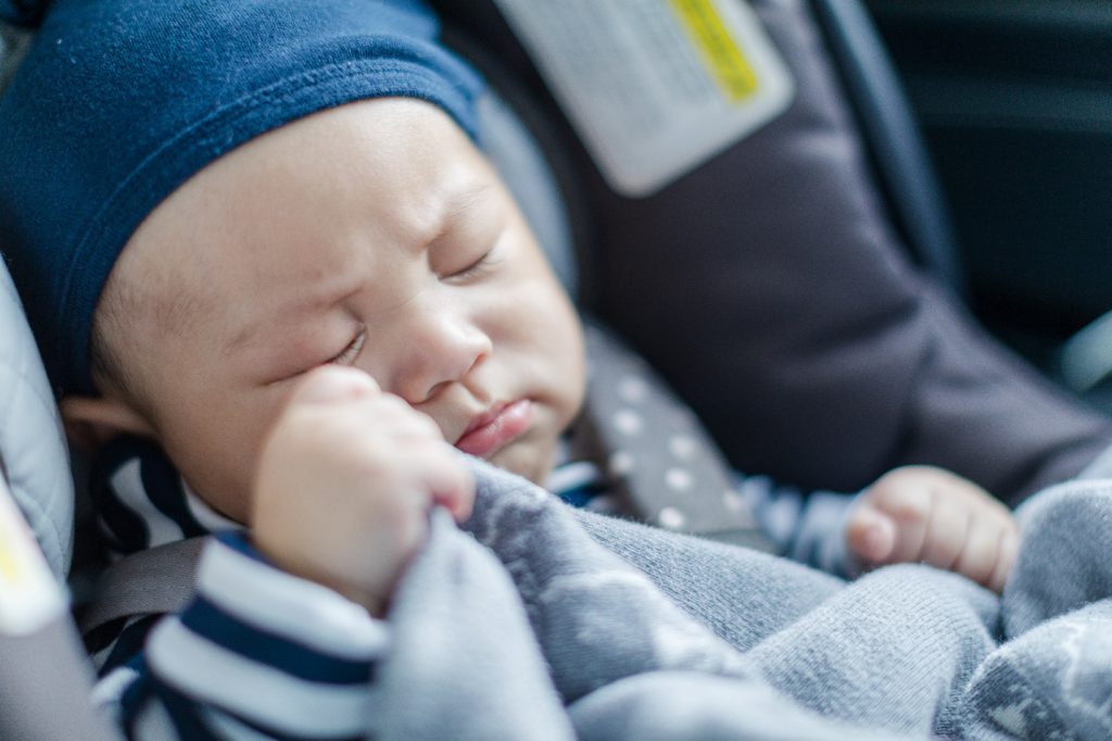 A baby sleeping in an infant car seat