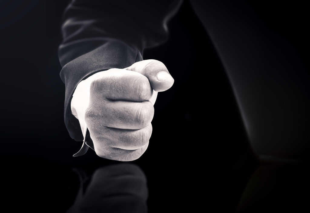 A man slamming his fist on a table. 