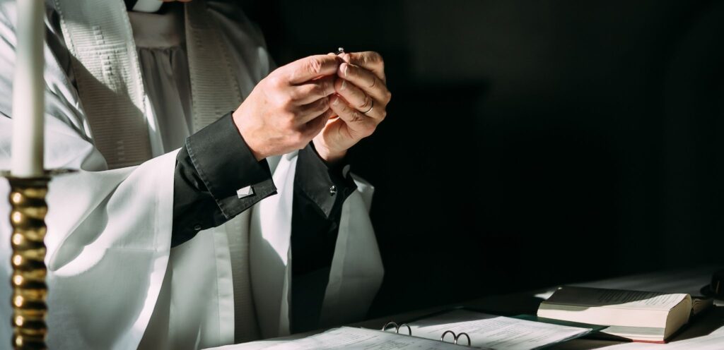 The priest holds the ring during the church wedding ceremony