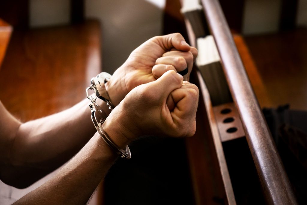 Male with a Handcuffed in the Church
