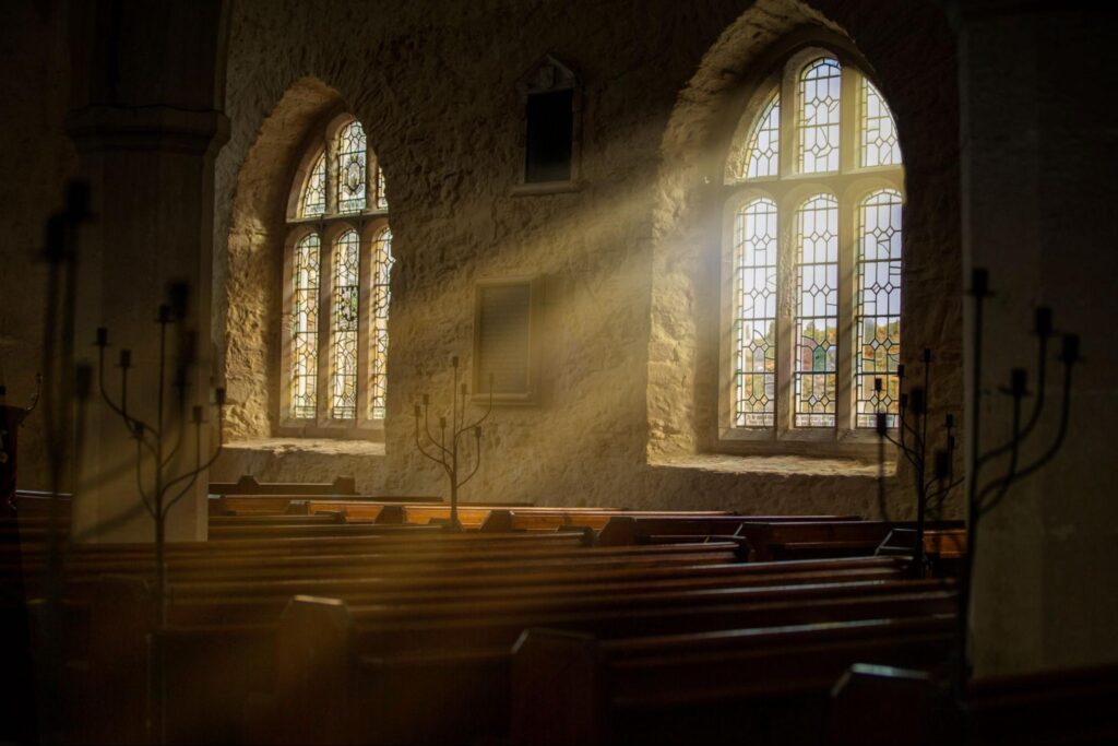 Stained glass windows with sun rays pouring in.