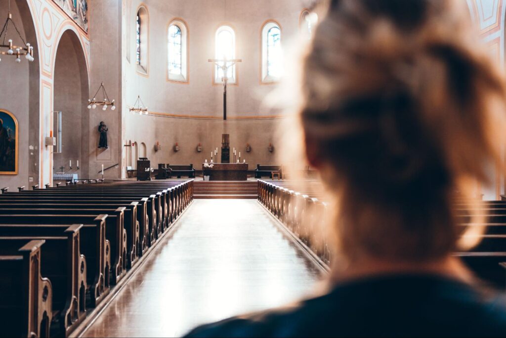 Woman in church heading to altar.
